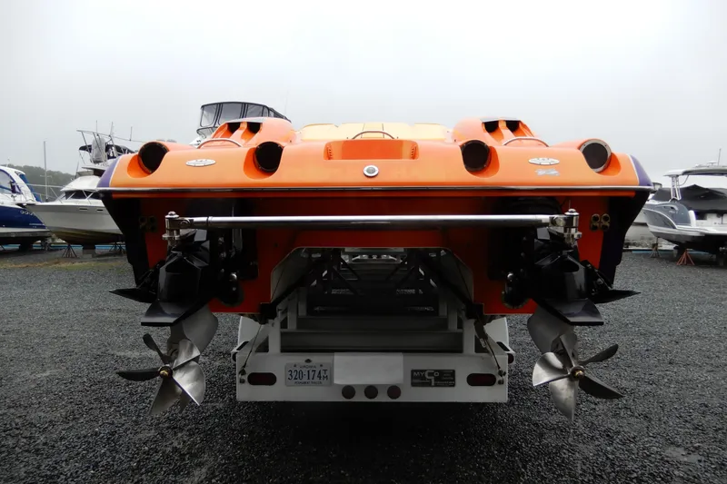 Slide: The Image of 2008 Nor-Tech 3600 Supercat in vibrant orange, rear view with dual propellers. - 11