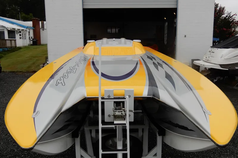 Slide: The Image of 2008 Nor-Tech 3600 Supercat powerboat with vibrant yellow and gray design in a garage setting. - 15