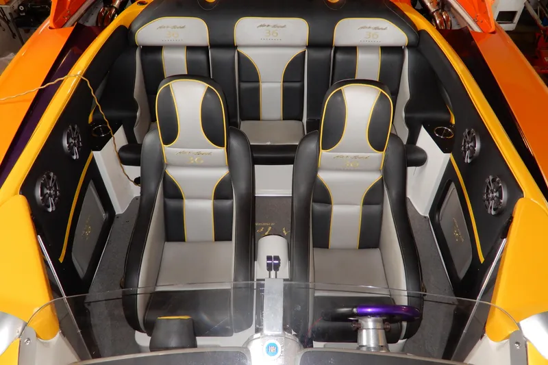 Slide: The Image of 2008 Nor-Tech 3600 Supercat interior with sleek black and gray seating, yellow accents. - 20