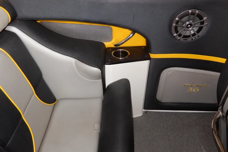Slide: The Image of 2008 Nor-Tech 3600 Supercat interior with black and yellow accents, speaker, and cup holder. - 22