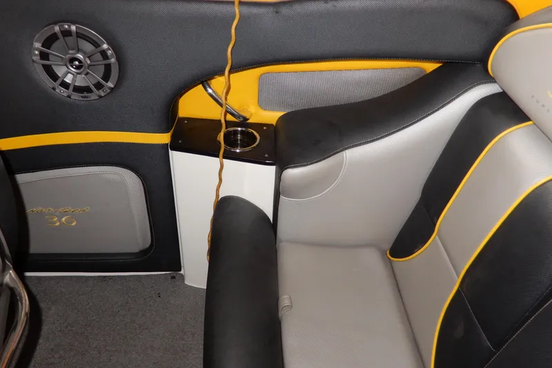 Slide: The Image of 2008 Nor-Tech 3600 Supercat interior with black and yellow seating, speaker, and cup holder. - 23