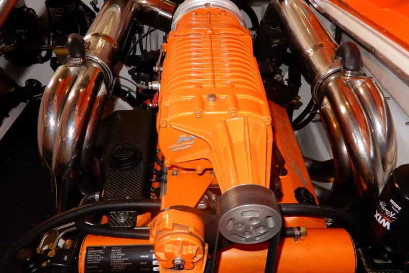 Slide: The Image of 2008 Nor-Tech 3600 Supercat engine with orange components and chrome exhaust pipes. - 31