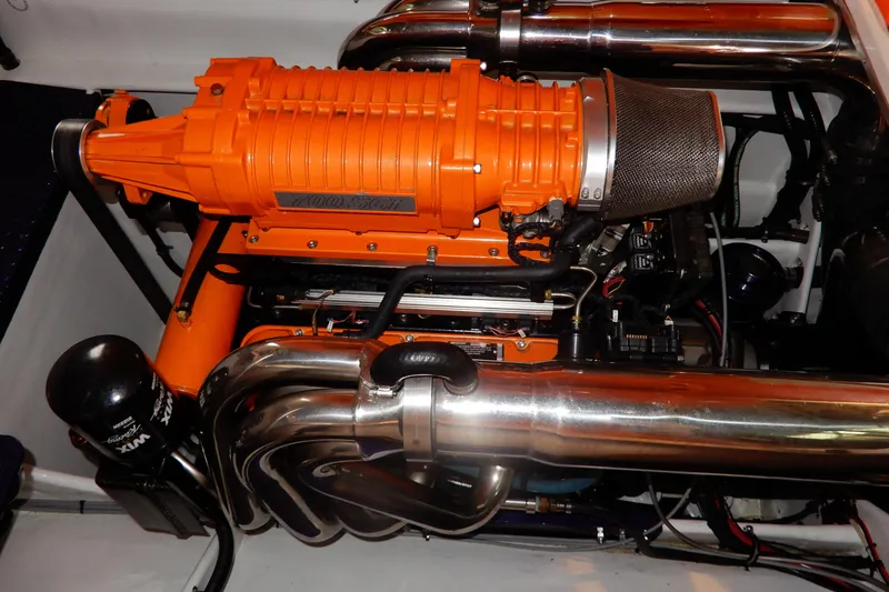 Slide: The Image of 2008 Nor-Tech 3600 Supercat engine with orange supercharger and chrome exhaust pipes. - 35