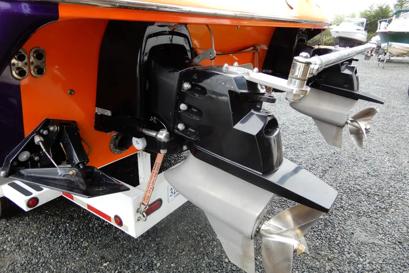 Slide: The Image of 2008 Nor-Tech 3600 Supercat boat with dual propellers and vibrant orange and purple hull. - 36