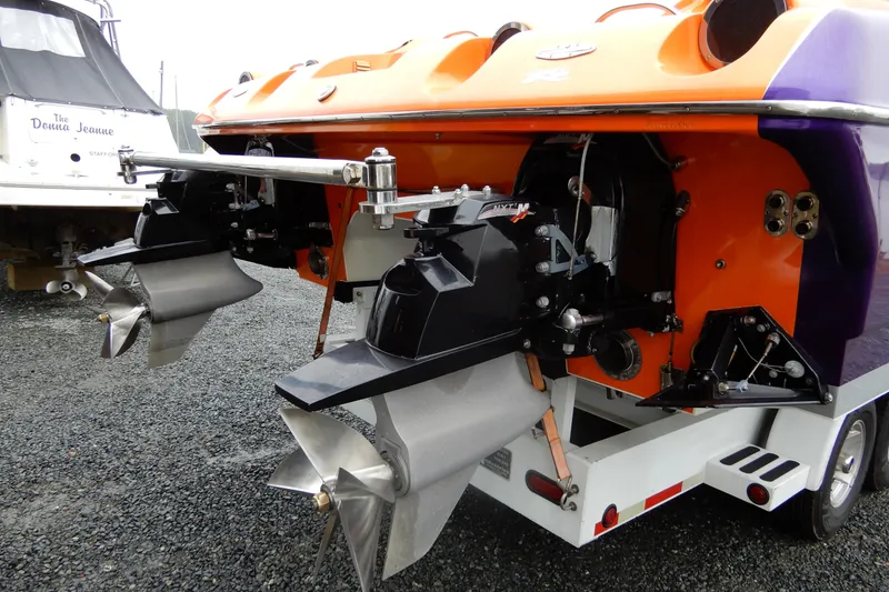 Slide: The Image of 2008 Nor-Tech 3600 Supercat boat with dual propellers and vibrant orange and purple hull. - 37