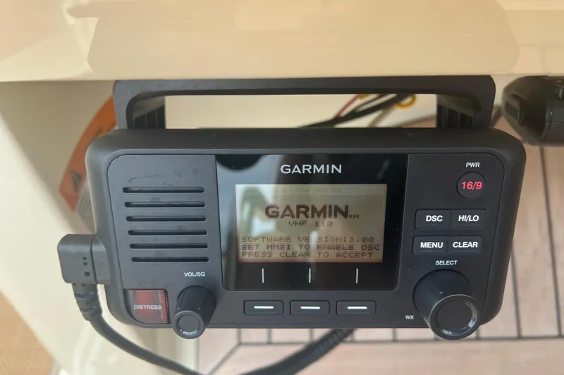 Slide: The Image of Garmin VHF 110 radio on 2017 Chris-Craft Launch 28 boat dashboard. - 10