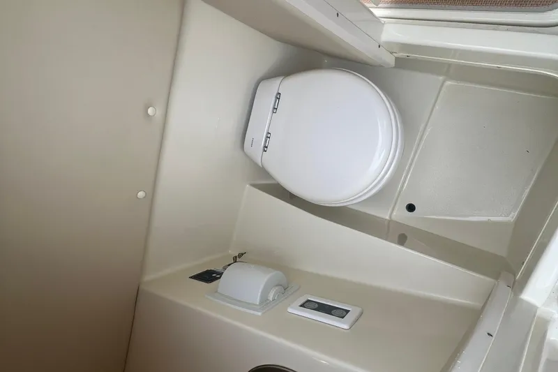 Slide: The Image of 2017 Chris-Craft Launch 28 boat interior bathroom with toilet and paper holder. - 11