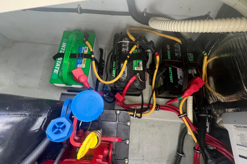 Slide: The Image of Battery compartment of a 2017 Chris-Craft Launch 28 boat with multiple connected batteries. - 14