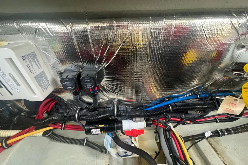 Slide: The Image of 2017 Chris-Craft Launch 28 engine compartment with wiring and insulation details. - 16