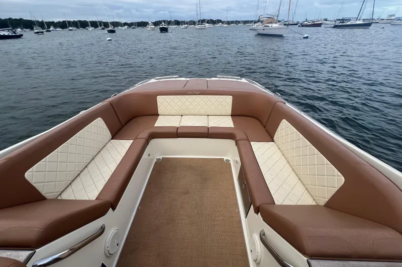 Slide: The Image of 2017 Chris-Craft Launch 28 boat with luxurious seating, docked in a serene harbor. - 2