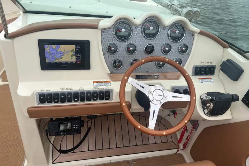 Slide: The Image of 2017 Chris-Craft Launch 28 dashboard with steering wheel, gauges, and navigation system. - 7