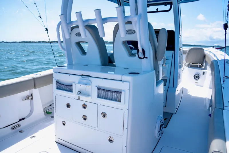 Slide: The Image of 2022 Sportsman Open 282 Center Console boat interior with seating and storage. - 10