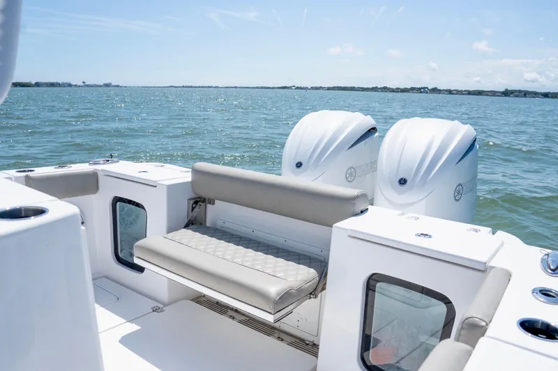 Slide: The Image of 2022 Sportsman Open 282 Center Console boat with twin Yamaha engines on the water. - 12