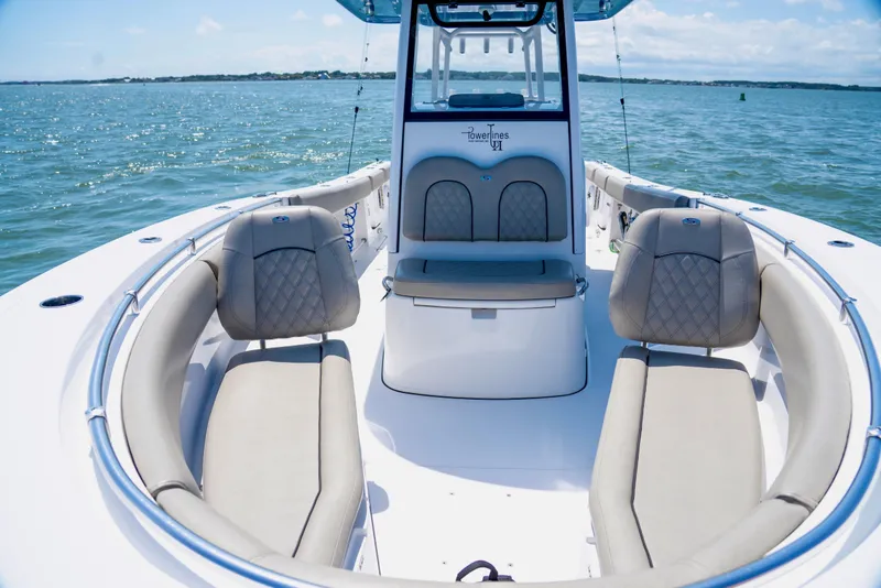 Slide: The Image of 2022 Sportsman Open 282 Center Console boat interior with cushioned seating on open water. - 13