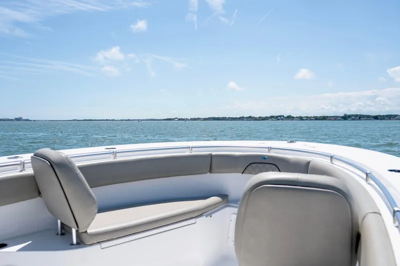 Slide: The Image of 2022 Sportsman Open 282 Center Console boat on calm waters under a clear blue sky. - 14