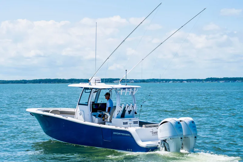 Slide: The Image of 2022 Sportsman Open 282 Center Console boat cruising on a sunny day. - 3