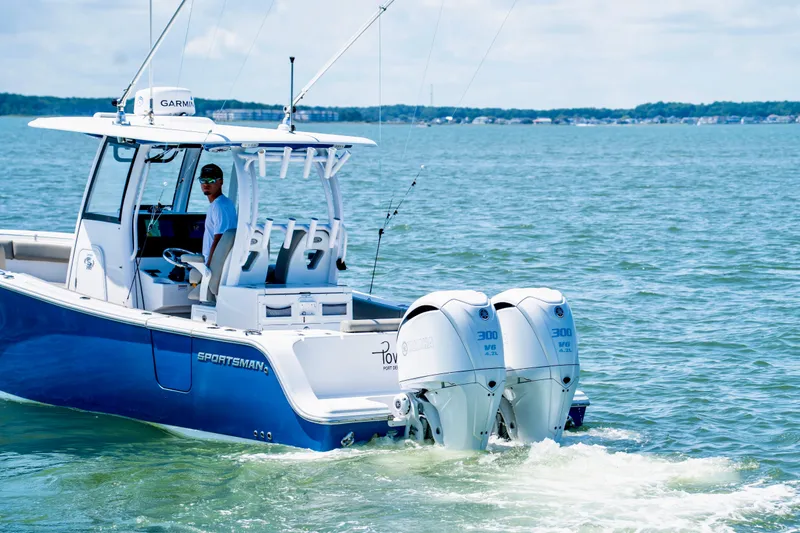 Slide: The Image of 2022 Sportsman Open 282 Center Console boat cruising on the water with twin engines. - 5