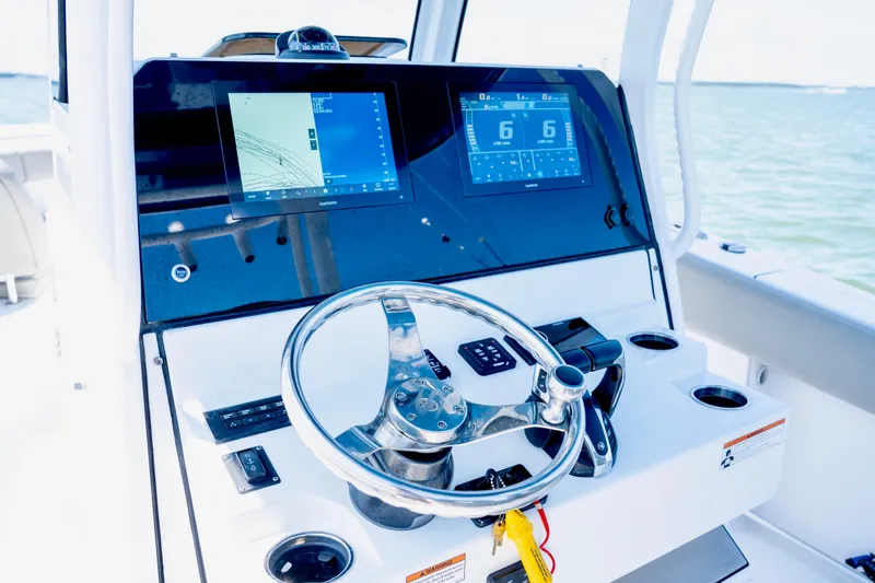 Slide: The Image of 2022 Sportsman Open 282 Center Console helm with dual displays and steering wheel. - 6