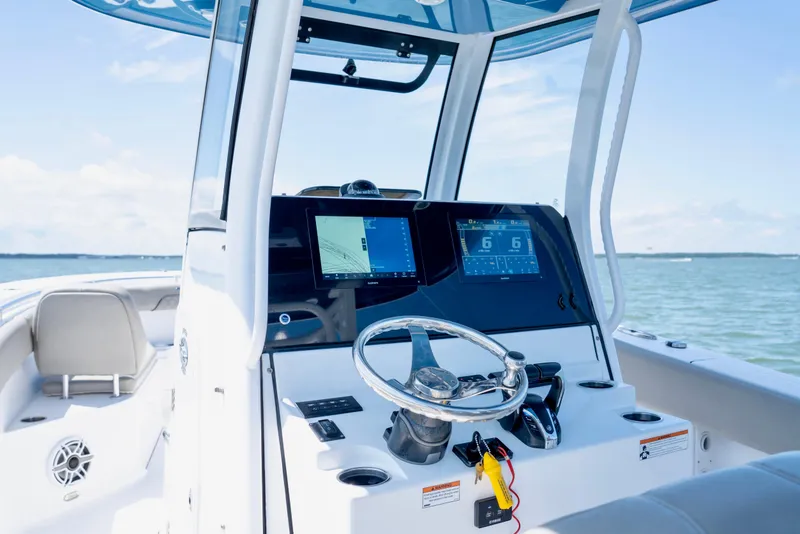 Slide: The Image of 2022 Sportsman Open 282 Center Console boat dashboard with navigation screens. - 7