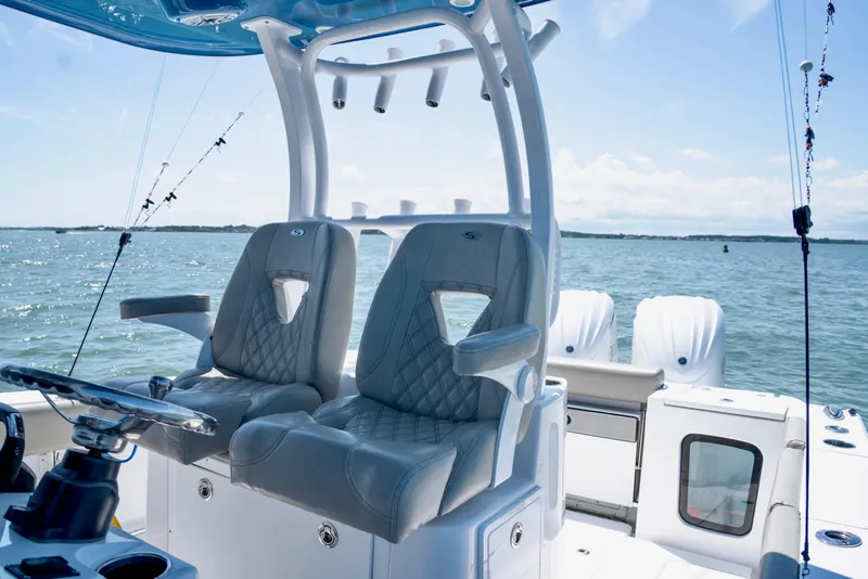 Slide: The Image of 2022 Sportsman Open 282 Center Console boat interior with luxurious seating on open water. - 8