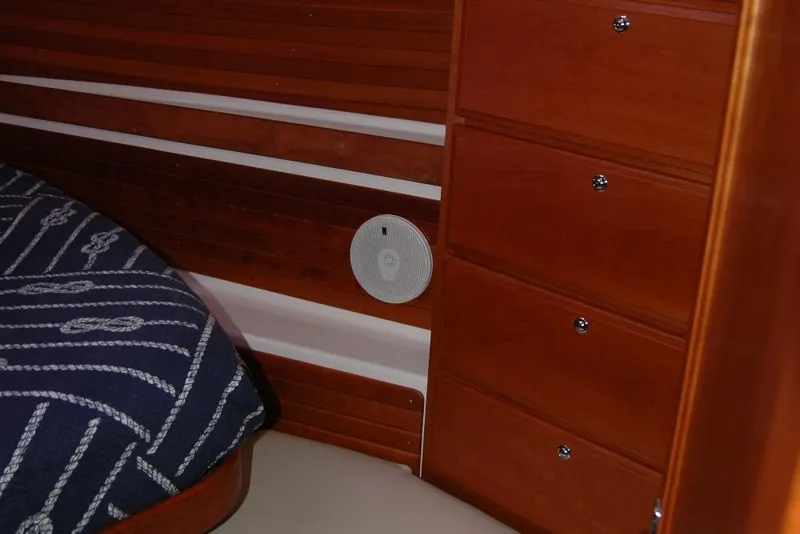 Slide: The Image of Interior of 2014 Back Cove 37 boat with wooden drawers and nautical-themed bedding. - 104