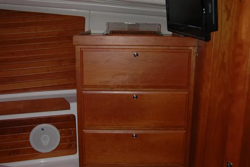 Slide: The Image of Wooden cabinetry and TV inside 2014 Back Cove 37 boat interior. - 106