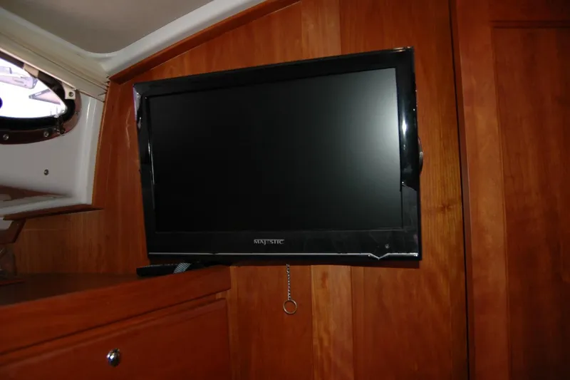Slide: The Image of Flat-screen TV mounted on wooden interior of 2014 Back Cove 37 boat. - 107