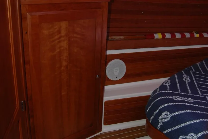 Slide: The Image of Interior of 2014 Back Cove 37 boat with wooden paneling and nautical-themed bedding. - 108