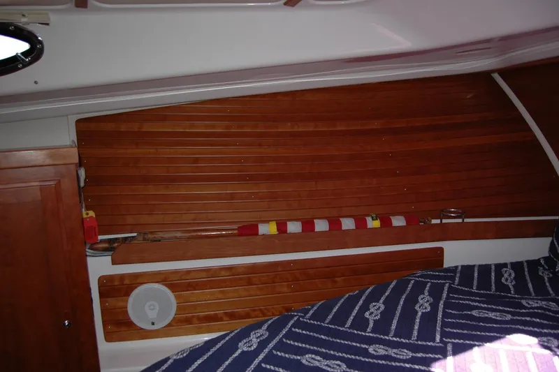 Slide: The Image of Interior of 2014 Back Cove 37 boat with wooden paneling and nautical-themed bedding. - 109
