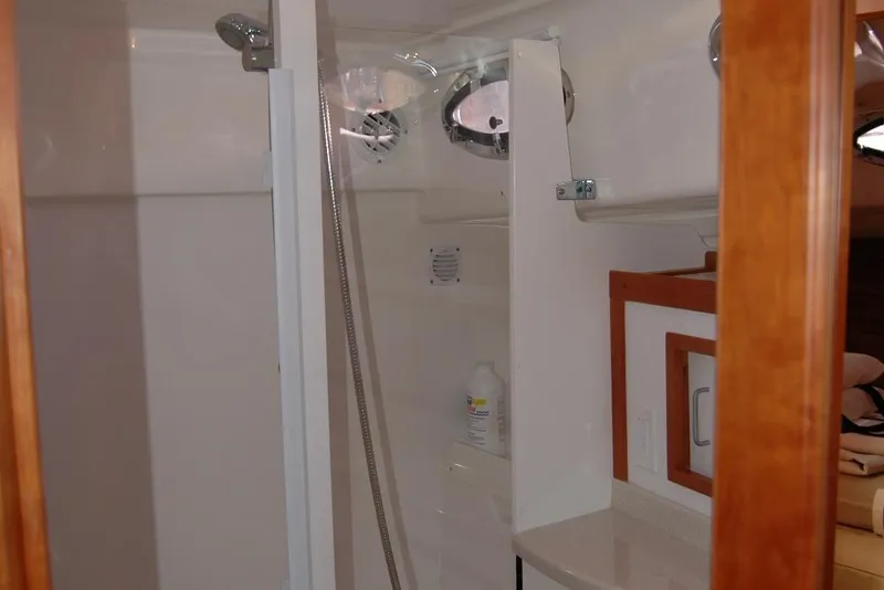 Slide: The Image of Bathroom interior of 2014 Back Cove 37 yacht, featuring shower and wooden accents. - 110