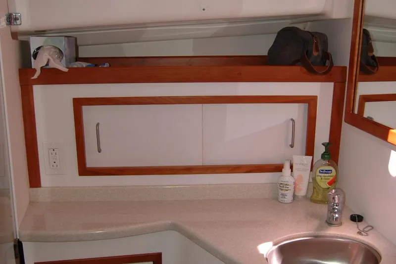 Slide: The Image of 2014 Back Cove 37 yacht bathroom with sink, countertop, and storage cabinet. - 112