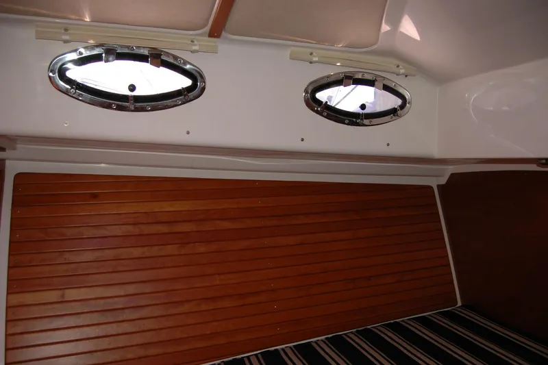 Slide: The Image of 2014 Back Cove 37 interior with wood paneling and oval portholes. - 114