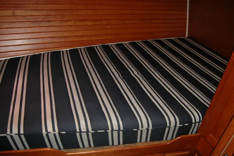 Slide: The Image of Striped mattress in 2014 Back Cove 37 boat cabin with wooden paneling. - 115