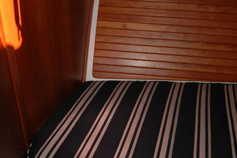 Slide: The Image of Interior of 2014 Back Cove 37 boat with striped cushion and wooden paneling. - 116