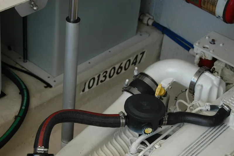 Slide: The Image of Engine compartment of a 2014 Back Cove 37 boat, showcasing mechanical components. - 122
