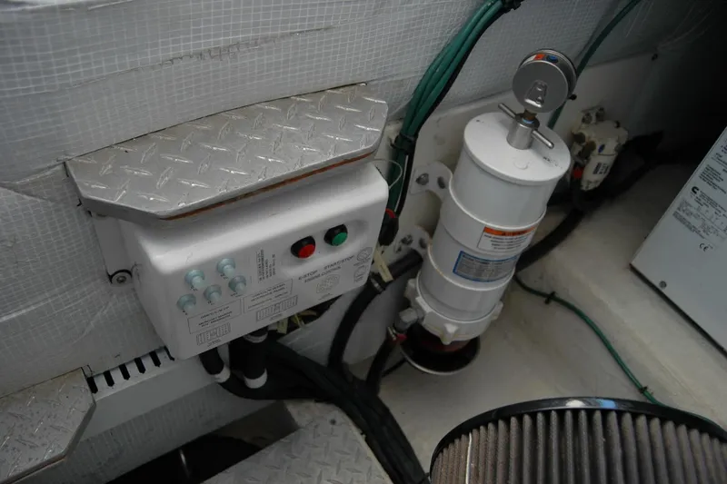 Slide: The Image of Engine compartment of a 2014 Back Cove 37 boat, featuring control panel and filter system. - 126