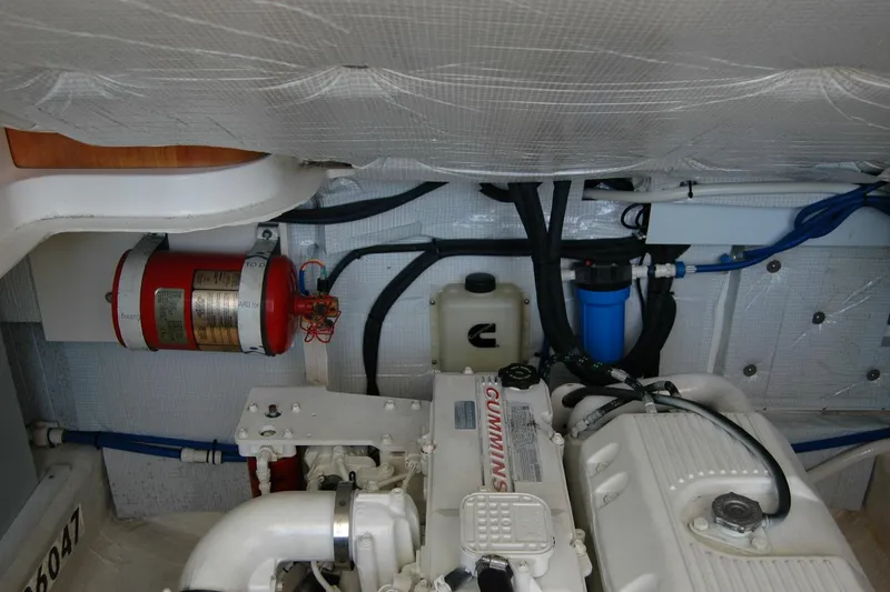 Slide: The Image of Engine room of 2014 Back Cove 37 boat with Cummins engine and fire extinguisher. - 132