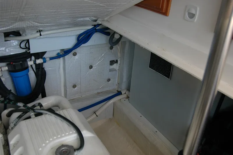 Slide: The Image of Engine compartment of a 2014 Back Cove 37 boat, featuring hoses and components. - 133