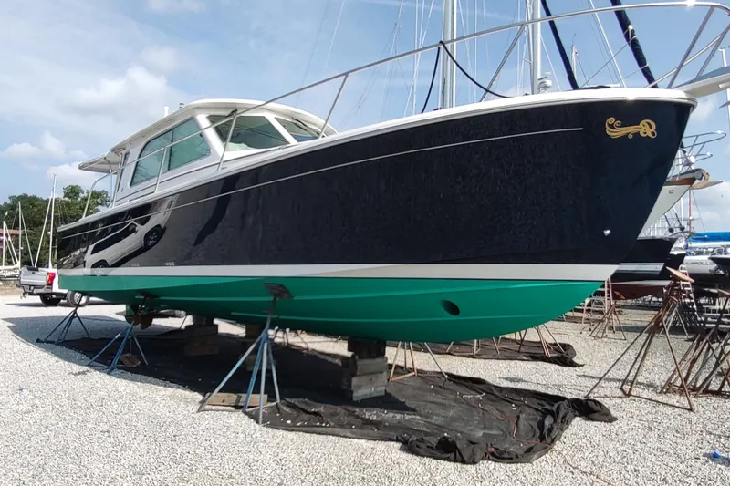 Slide: The Image of 2014 Back Cove 37 boat on stands in a marina, side view. - 139
