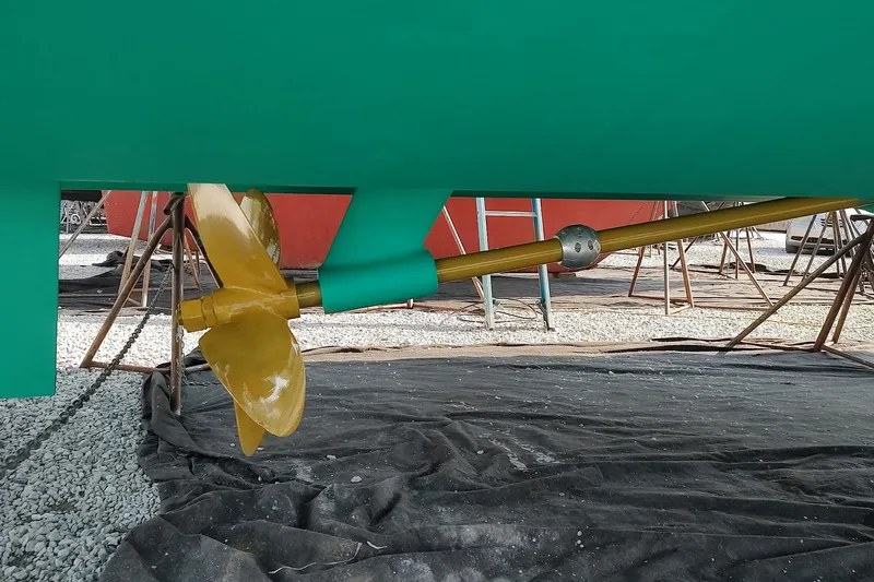 Slide: The Image of 2014 Back Cove 37 boat propeller and shaft on display in a shipyard. - 140