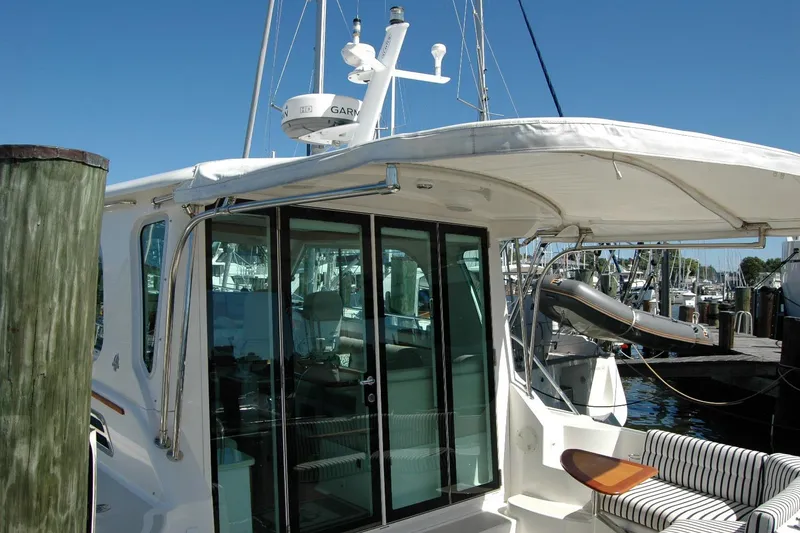 Slide: The Image of 2014 Back Cove 37 yacht docked, featuring a sleek design and spacious interior. - 18