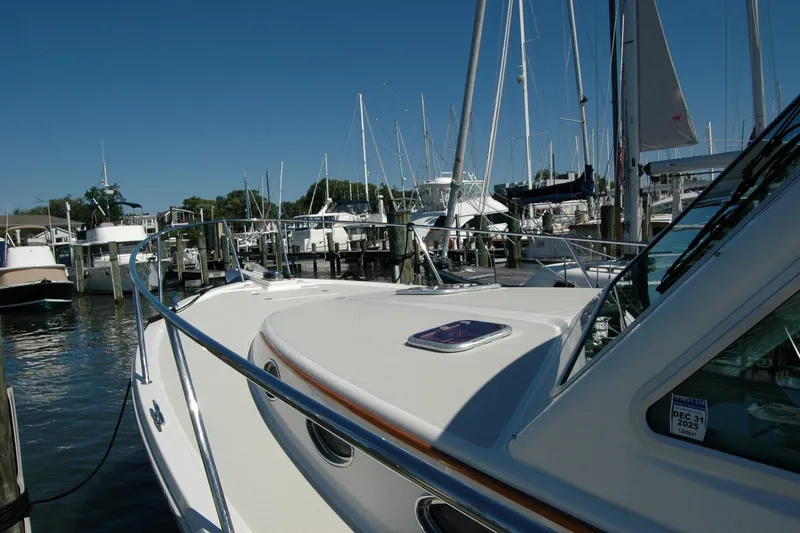 Slide: The Image of 2014 Back Cove 37 yacht docked at a marina, surrounded by sailboats under a clear blue sky. - 20