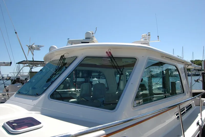 Slide: The Image of 2014 Back Cove 37 yacht docked, showcasing sleek design and modern navigation equipment. - 21