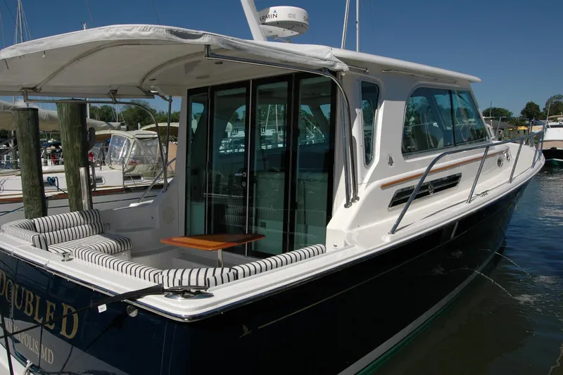 Slide: The Image of 2014 Back Cove 37 yacht docked, featuring sleek design and comfortable seating area. - 25