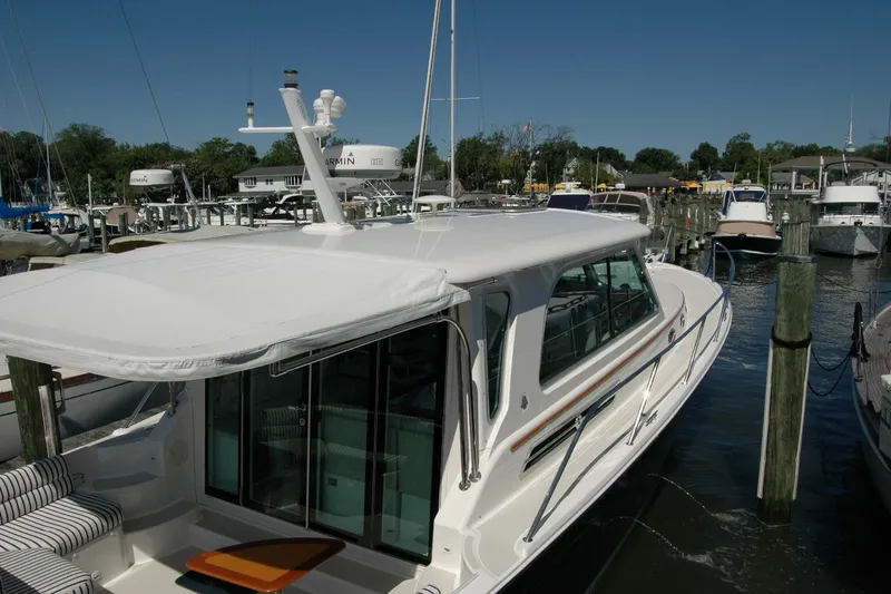 Slide: The Image of 2014 Back Cove 37 yacht docked at marina under clear blue sky. - 26