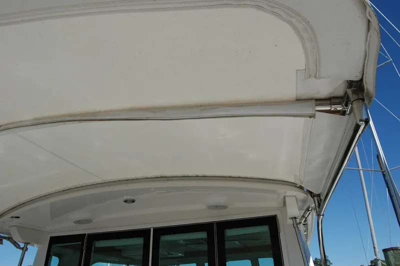 Slide: The Image of 2014 Back Cove 37 boat canopy and structure detail under clear sky. - 30