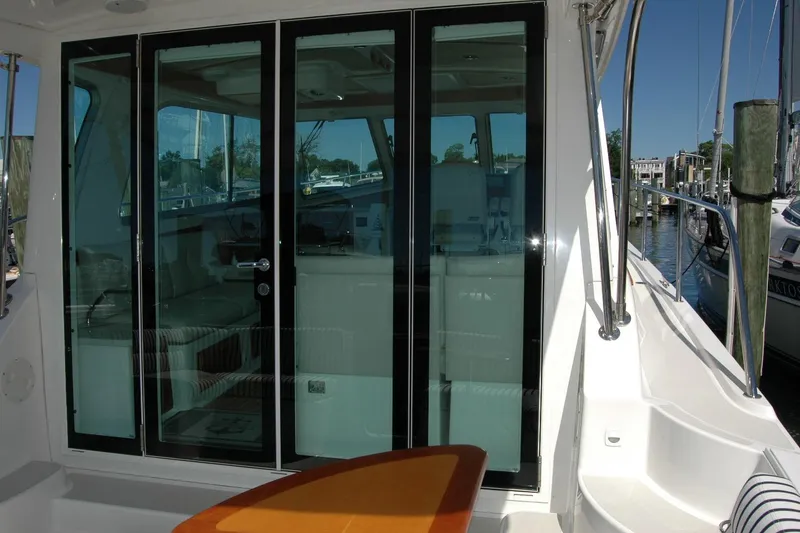 Slide: The Image of 2014 Back Cove 37 yacht with glass doors, docked at a marina. - 31