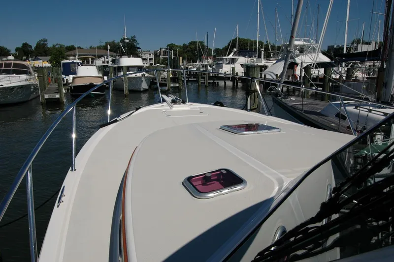 Slide: The Image of 2014 Back Cove 37 yacht docked at marina, showcasing sleek deck design. - 34