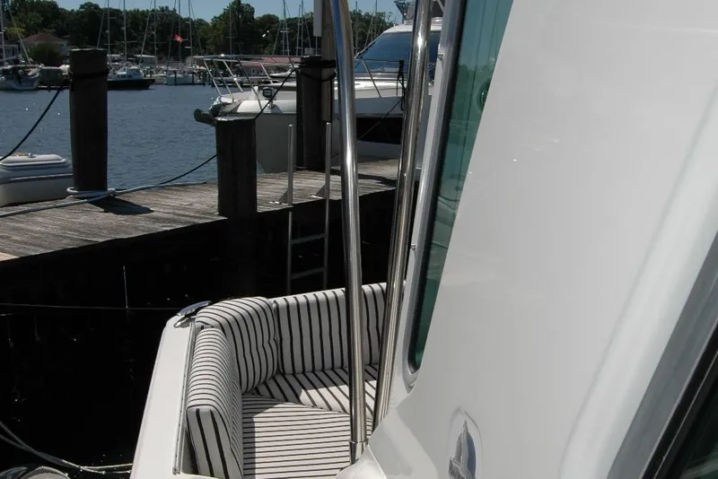 Slide: The Image of 2014 Back Cove 37 yacht with striped seating at a marina dock. - 43