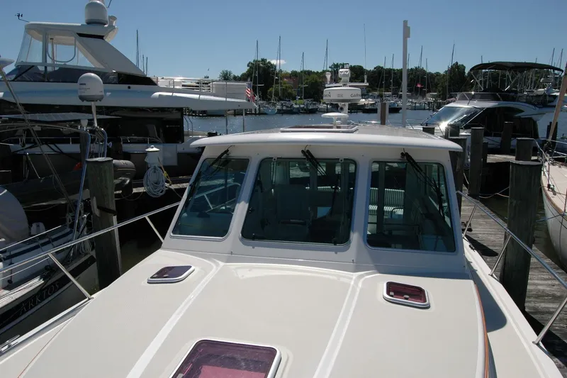 Slide: The Image of 2014 Back Cove 37 yacht docked at marina, surrounded by other boats. - 46